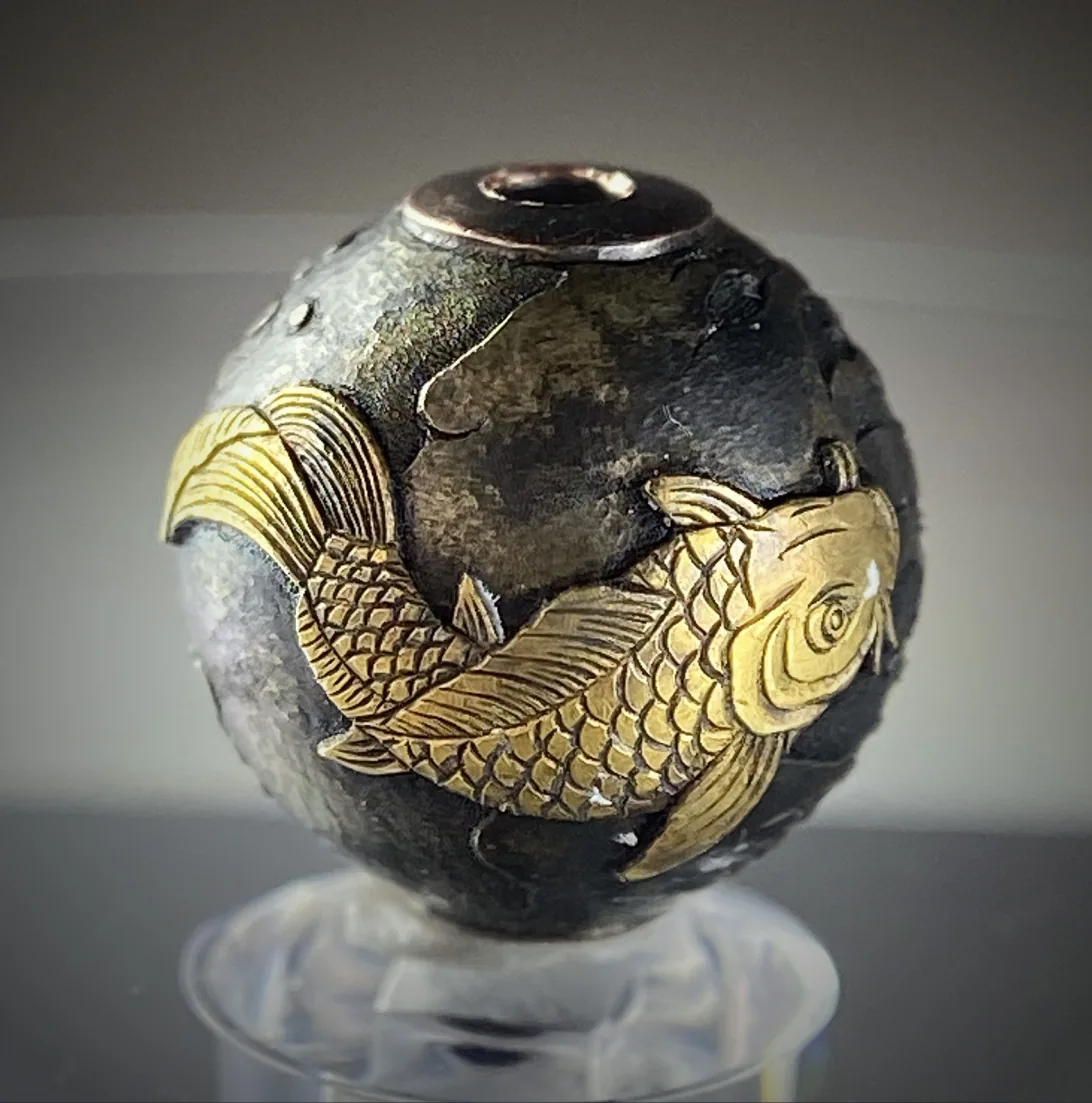 Hammered sphere with a golden koi