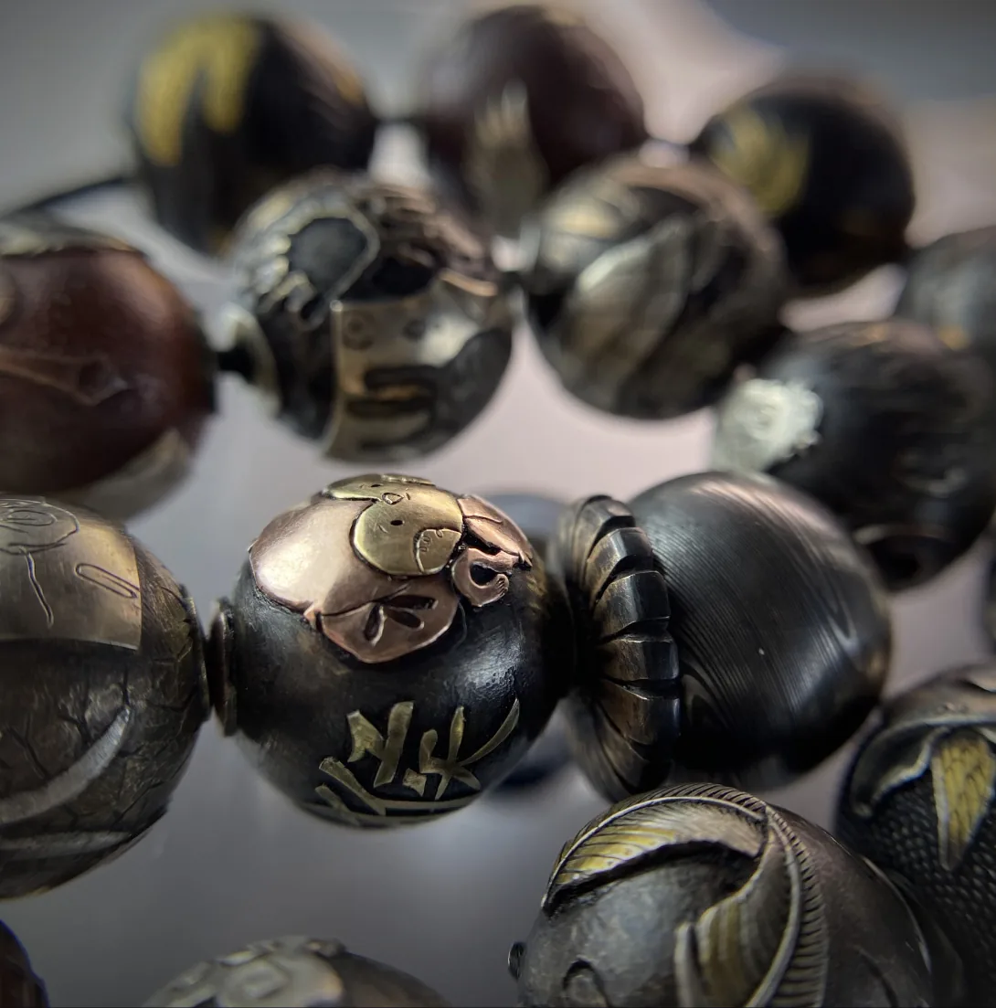 Patinated beads with golden details